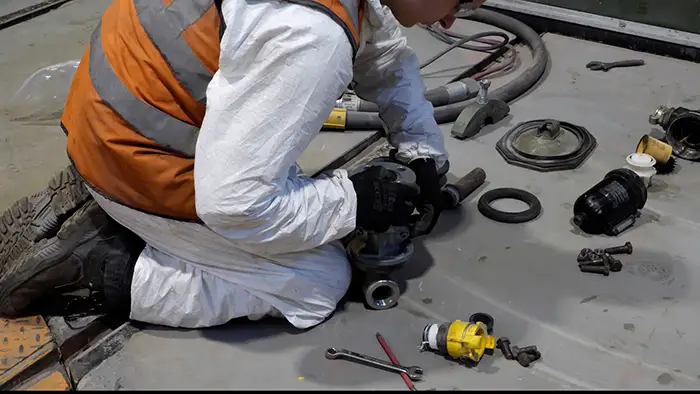 Service engineer maintaining blast equipment