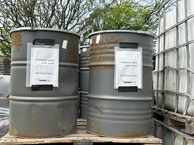 recycled abrasives in drums ready for collection